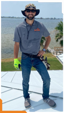 Owner of Helpful Roofing standing on a roof